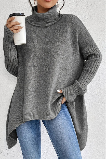 Suéter oversize de mujer con cuello alto y dobladillo asimétrico
